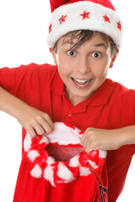 Boy holding up Christmas stocking.