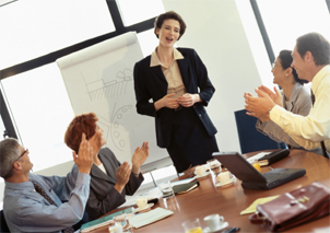 Woman being applauded in meeting